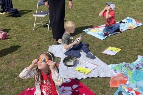 Look up! DC-area residents take in rare sight of partial solar eclipse