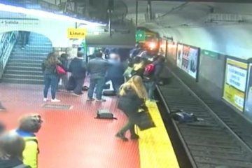 WATCH: Woman falls onto subway tracks and is pulled to safety